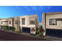 Modern home boasts sleek design, glass garage door, manicured landscaping and inviting curb appeal at 20 Lakefront Dr, Henderson, NV 89011