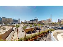 Expansive city view showcasing palm trees, buildings, and a clear blue sky, creating an appealing urban landscape at 211 E Flamingo Rd # 202, Las Vegas, NV 89169