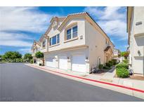 Charming townhome featuring multiple garages, complemented by well-maintained landscaping at 2558 Lazy Saddle Dr, Henderson, NV 89002