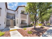 Inviting multi-story condo building boasts well-maintained landscaping and convenient stair access to upper units at 2615 W Gary Ave # 1053, Las Vegas, NV 89123