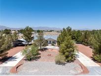 Charming home with desert landscaping, circular driveway, RV parking and mountain views at 2950 Winchester Ave, Pahrump, NV 89048
