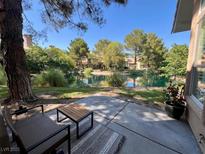 A serene patio view overlooking a lush pond and mature landscaping at 4963 Crooked Stick Way, Las Vegas, NV 89113
