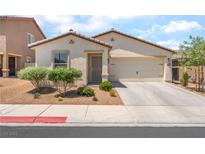 Charming single-story home featuring desert landscaping, a two-car garage, and a well-maintained front yard at 518 Descubir Ave, North Las Vegas, NV 89081