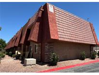 Attractive multi-unit building with desert landscaping, brick and stucco exterior, and a tile roof at 5499 Indian River Dr # 356, Las Vegas, NV 89103