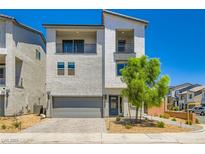 Modern two-story home with a gray color scheme, a two-car garage, and minimal landscaping at 5804 Gossamer Stone Ct, Las Vegas, NV 89141