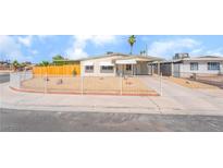 Charming single-story home featuring a well-kept front yard with a fence and a covered front porch at 600 Berry Cir, Las Vegas, NV 89107