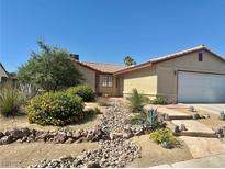Charming single-story home featuring a rockscaped front yard, mature landscaping, and a two car garage at 6357 Cobalt Ln, Las Vegas, NV 89146