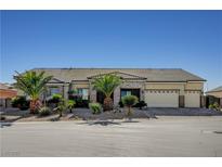 Single story home featuring desert landscaping, stone accents, tile roof, and three car garage at 6971 Moaning Cavern St, Las Vegas, NV 89131