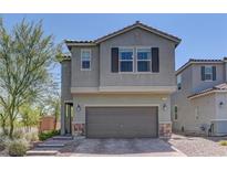 Charming two-story home featuring a two-car garage and brick-paved driveway at 7705 Alder Forest St, Las Vegas, NV 89113