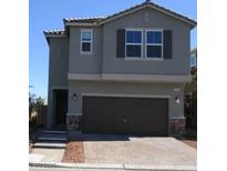 Two-story home showcasing neutral paint, a dark brown garage door, and manicured landscaping at 7705 Alder Forest St, Las Vegas, NV 89113