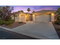 Charming single-story home with a well-manicured yard, desert landscaping, and multi-car garage at 8623 Kennedy Heights Ct, Las Vegas, NV 89131