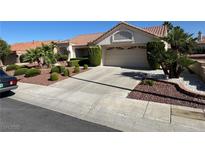 Charming single-story home featuring a tile roof, desert landscaping, and an attached two-car garage at 9505 Quail Ridge Dr, Las Vegas, NV 89134
