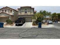 Two-story stucco home featuring a well-maintained yard and attached garage on a sunny day at 9564 Fresh Crown Ct, Las Vegas, NV 89148