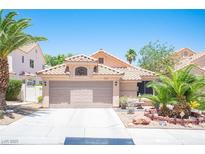 Charming single-story home with a well-manicured front yard, desert landscaping, and a two-car garage at 9632 Spanish Steps Ln, Las Vegas, NV 89117