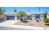 Charming single-story home with a two-car garage and desert landscaping in the front yard at 9728 Drumcannon Ave, Las Vegas, NV 89129