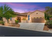 Charming single-story home with a well-manicured lawn and a spacious two-car garage at 10348 Hawks Wing St, Las Vegas, NV 89178