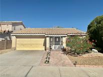 Charming single-story home featuring a tile roof and a well-manicured front yard at 1461 Harmony Hill Dr, Henderson, NV 89014
