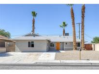 Charming single-story home featuring desert landscaping and an inviting orange front door at 2005 Jansen Ave, Las Vegas, NV 89101