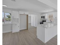 Modern kitchen featuring white cabinets, stainless steel appliances and light, wood-look flooring at 2005 Jansen Ave, Las Vegas, NV 89101