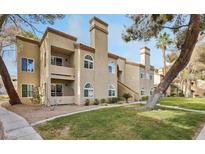 Inviting multi-story condo with well-maintained landscaping and classic stucco exterior at 3145 E Flamingo Rd # 1045, Las Vegas, NV 89121