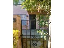 Inviting front entrance with secure gated access to the home's front porch and verdant landscaping at 4338 Caliente St # 12, Las Vegas, NV 89119