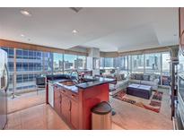 Bright, open living space featuring floor-to-ceiling windows with stunning city views and modern furnishings at 4575 Dean Martin Dr # 1112, Las Vegas, NV 89103