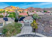 Charming two-story home featuring a spacious driveway and gorgeous mountain views in the background at 53 Precipice Ct, Henderson, NV 89002