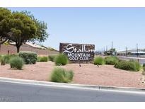 Stallion Mountain Golf Club signage surrounded by desert landscaping and situated near a paved road at 5935 Saddle Horse Ave, Las Vegas, NV 89122
