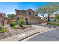 Charming two-story home with well-manicured landscaping and a welcoming curb appeal on a sunny day at 636 Pacific Cascades Dr, Henderson, NV 89012