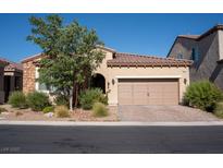 Charming single-story home with a well-maintained front yard, desert landscaping and a two-car garage at 832 Gallery Course Dr, Las Vegas, NV 89148