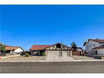Charming single-story home with a two-car garage and a well-maintained front yard at 8517 Soneto Ln, Las Vegas, NV 89117