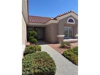 Charming front yard with manicured landscaping and a welcoming walkway to the front door at 10036 Keysborough Dr, Las Vegas, NV 89134