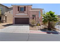 Charming home featuring a well-manicured front yard with a two car garage and desert landscaping at 10478 Beallsville St, Las Vegas, NV 89141