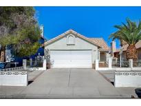 Charming single-story home with a two-car garage and a well-maintained front yard with mature trees at 1950 Turtlerock St, Las Vegas, NV 89142