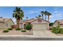 Charming single-story home with a two car garage, well-kept yard, and a desert landscaped front yard at 1981 Spring Lake Dr, Henderson, NV 89002