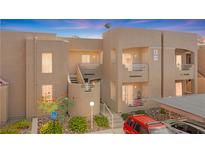 Inviting two-story condo showcasing well-maintained landscaping and a charming facade at 2243 Aspen Mirror Way # 102, Laughlin, NV 89029