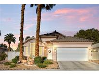 Charming single-story home featuring a two-car garage, desert landscaping, and a welcoming front entrance at 2512 Huber Heights Dr, Las Vegas, NV 89128