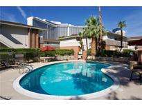 Inviting community pool with lounge chairs and tables provides a relaxing outdoor retreat for residents at 2831 Geary Pl # 2918, Las Vegas, NV 89109