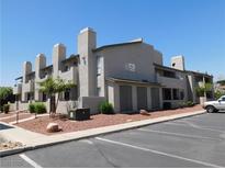 Inviting exterior of a two-story residential building with manicured landscaping and ample parking at 2921 Country Manor Ln # 139, Las Vegas, NV 89115