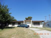 Single-story home with a flat roof, a small front porch, and a driveway at 3175 Palmdale St, Las Vegas, NV 89121