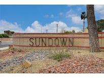 Sundown community entrance sign, featuring desert landscaping, a brick base, and clear blue skies at 4036 Nightingale Ct, Las Vegas, NV 89107