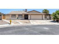 Single-story home featuring desert landscaping, a two-car garage, and neutral exterior color scheme at 4458 El Quinta Ct, Las Vegas, NV 89121