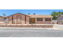Charming single-story home featuring desert landscaping and a stone accent wall for added curb appeal at 4784 El Escorial Dr, Las Vegas, NV 89121