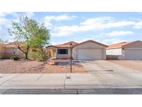 Charming single-story home with desert landscaping, a two-car garage, and a neatly maintained front yard at 5009 Peaceful Pond Ave, Las Vegas, NV 89131