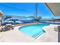 Sparkling pool area featuring a dolphin mural, perfect for outdoor relaxation and entertainment at 5093 Sun Valley Dr, Las Vegas, NV 89122