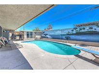 Beautiful pool with a diving board and lovely mural creating a relaxing backyard oasis at 5093 Sun Valley Dr, Las Vegas, NV 89122