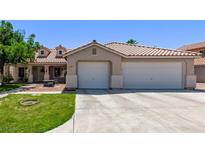 Charming single-story home with a large driveway and a well-manicured lawn in a suburban setting at 6307 Dusty Mile Ct, North Las Vegas, NV 89031