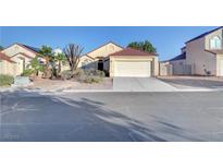 Charming single-story home with desert landscaping and a two-car garage on a sunny day at 641 Bay Bridge Dr, North Las Vegas, NV 89032