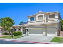 Charming two-story home featuring a three-car garage, landscaped yard, and a tile roof, basking in the bright sunlight at 7537 Splashing Rock Dr, Las Vegas, NV 89131