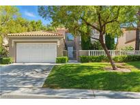 Charming two-story home showcasing a well-manicured lawn and an attached two-car garage at 8215 Crow Valley Ln, Las Vegas, NV 89113